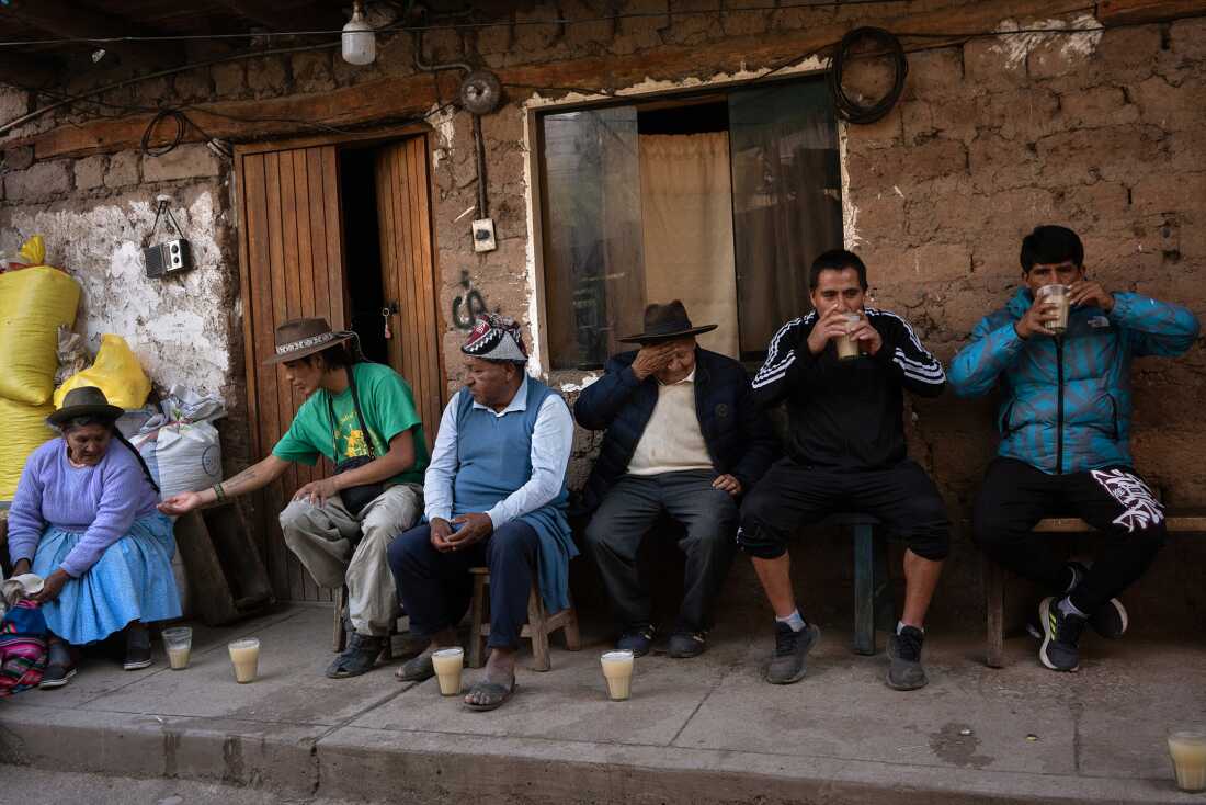 People enjoying chicha, the fermented corn beverage, in a checheria in Calca, near Cusco, on November 6, 2024. Originally sacred to Indigenous peoples, chicha also became a term for Peruvian cumbia, reflecting its cultural significance and controversy.