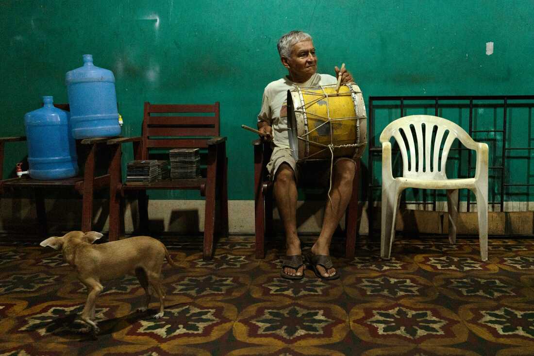 Helner Misael Sánchez Casanova, aka Tacto, a member of Los Wembler's de Iquitos, plays the bombo drum at his home in Iquitos, Peru, on October 26, 2024. Los Wembler's pioneered the cumbia Amazonica sub-genre, blending Colombian cumbia with Amazonian rhythms, psychedelic guitar, jungle sounds, and more.