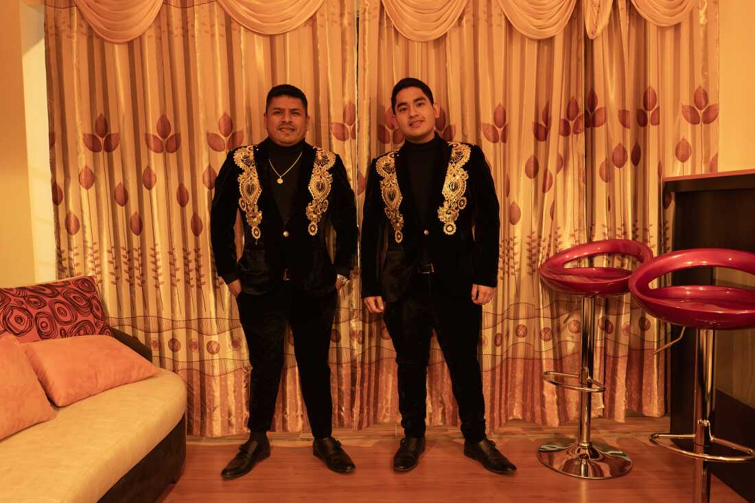 Jose Luis Mendoza Zapata, bongo player, and Leandro Lozada, singer of ArmonÃa 10, prepare for a concert in Sicuani, Peru, on November 4, 2024.
