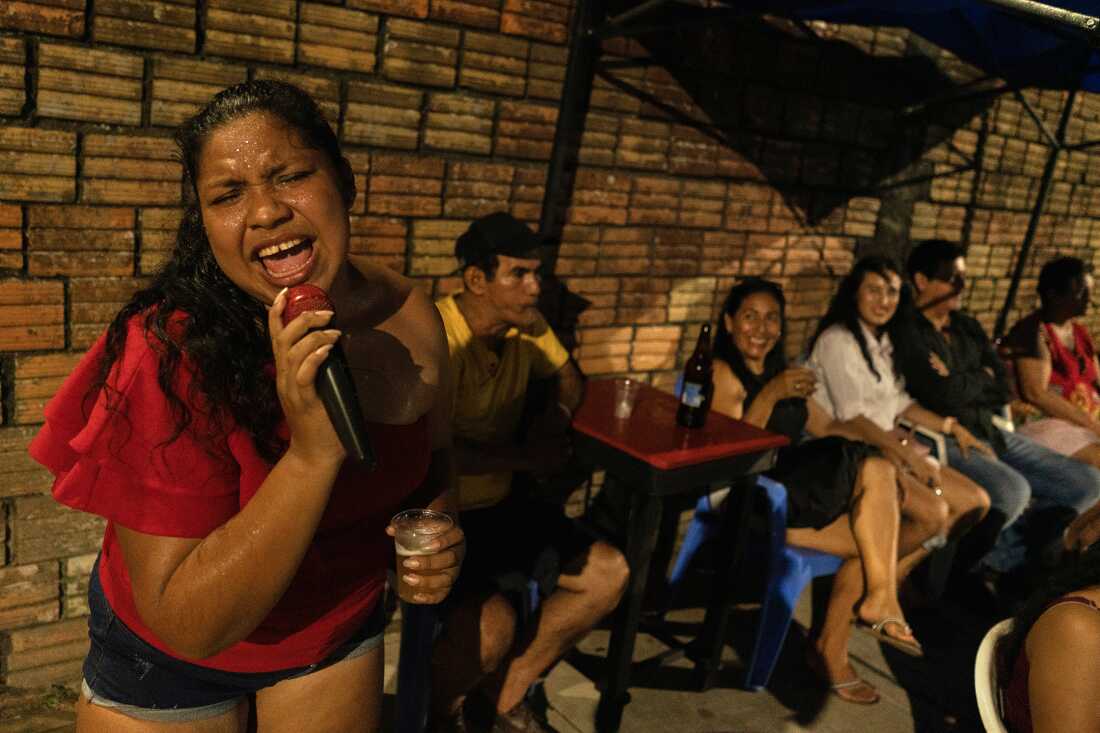 Estella Gonzalez of Son Estrella sings on the streets of Iquitos on October 27, 2024, promoting the band known for cumbia and tropical music.