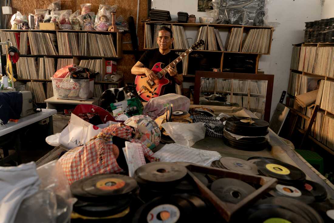 Pancho Acosta of Compay Quinto holds his guitar in his Lima home on November 2, 2024. Acosta contributed to the creation of chicha's distinctive sound, blending electric guitar with Colombian cumbia, Andean huayno, Cuban guaracha, rock 'n roll, and other genres.