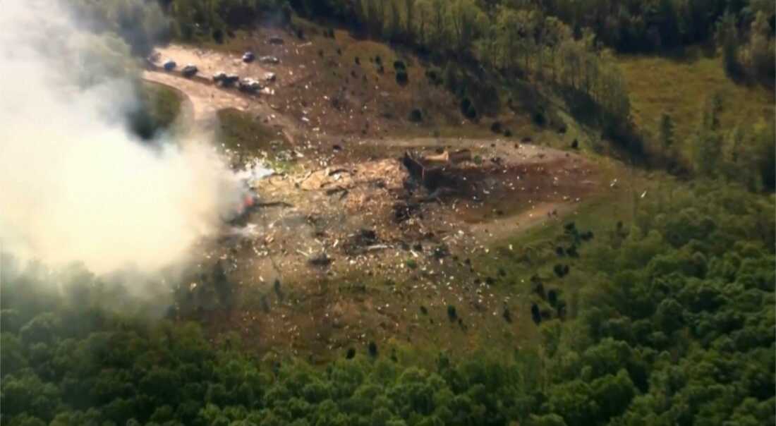 Smoke rises over debris and damaged vehicles after a powerful explosion at a military explosives plant in Hickman County, Tennessee, October 10, 2025.