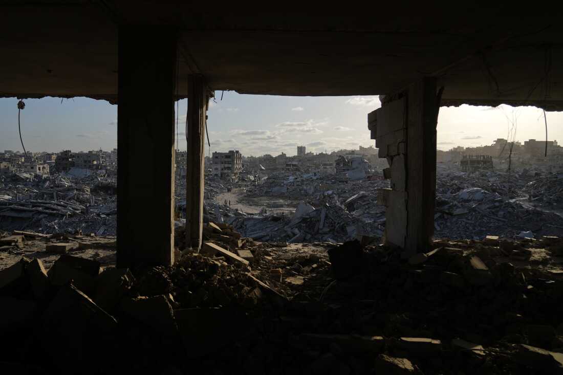 Displaced Palestinians walk through the devastated Sheikh Radwan neighborhood in Gaza City, Oct. 11, 2025.