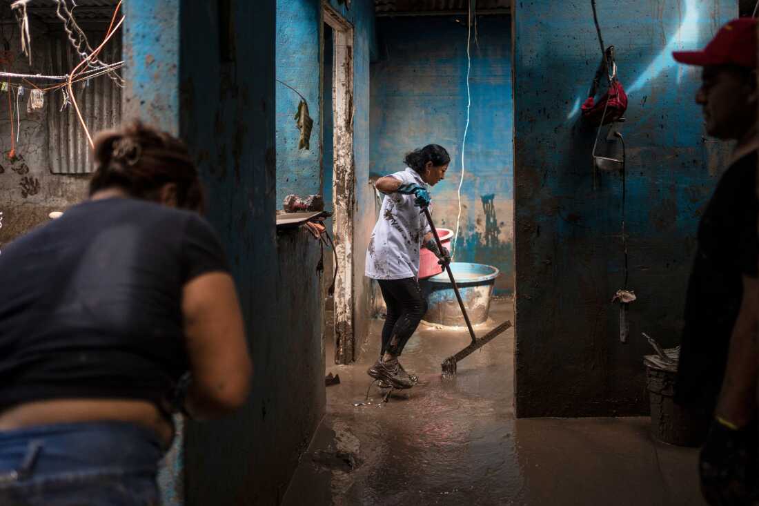 Residents cleaning the Olvera Gomez family home in Poza Rica, Veracruz, Mexico, after severe flooding.
