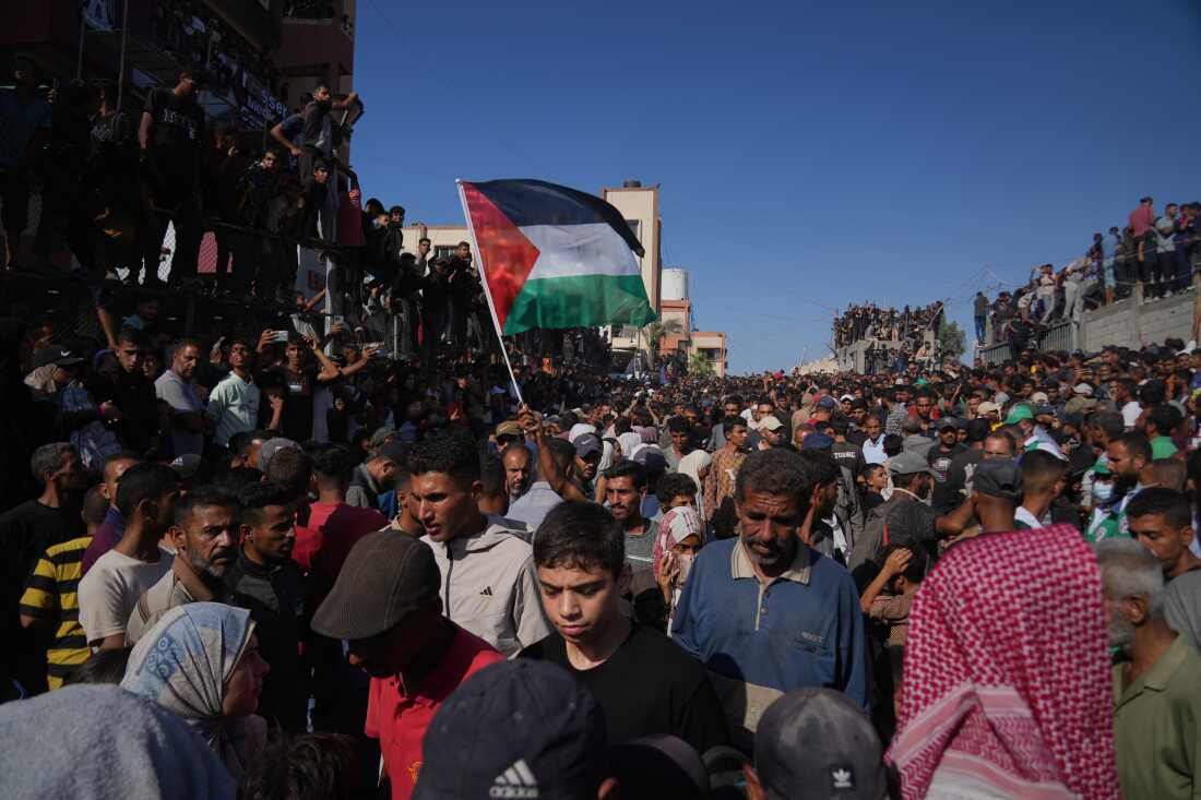 People gather to greet freed Palestinian prisoners as they arrive in the Gaza Strip after their release from Israeli jails under a ceasefire agreement between Hamas and Israel, outside Nasser Hospital in Khan Younis, southern Gaza Strip, Monday.