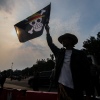 Human rights activists holding anime-themed flags during a rally in Jakarta, Indonesia
