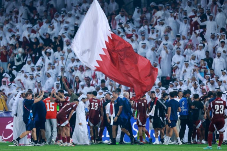 Qatar players celebrate with fans at Jassim bin Hamad Stadium