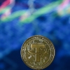 Gold-plated souvenir stablecoin issued by Tether displayed in London.