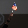 An election worker holds a U.S. flag while assisting voters at a polling station in Las Vegas on Election Day, November 5, 2024.