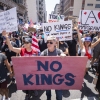 Marchers holding signs during the No Kings national rally in downtown Los Angeles on June 14, 2025.