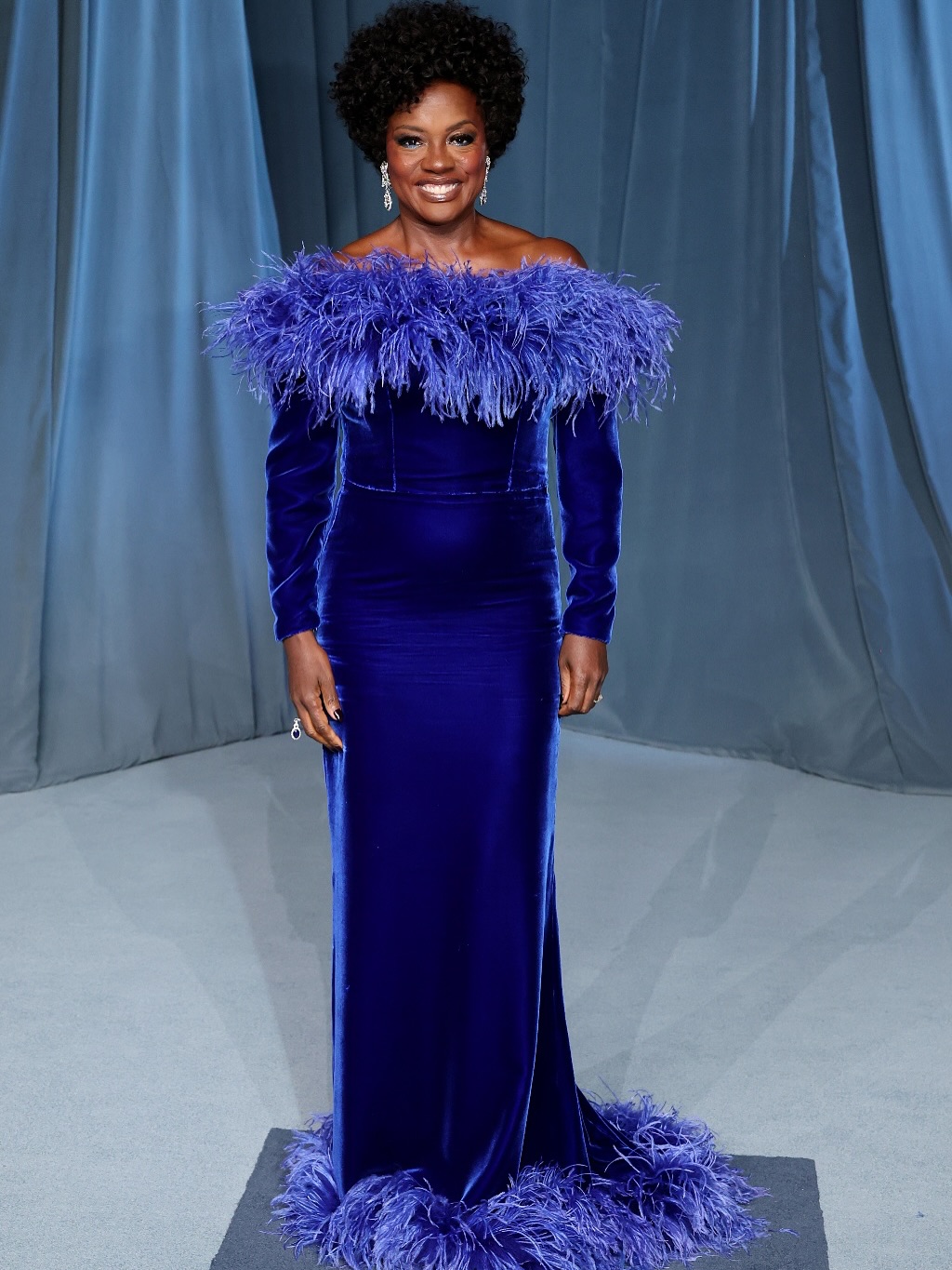 Viola Davis wearing a sapphire-blue velvet Gucci gown with off-the-shoulder neckline and feather trim at the 2025 Academy Museum Gala.