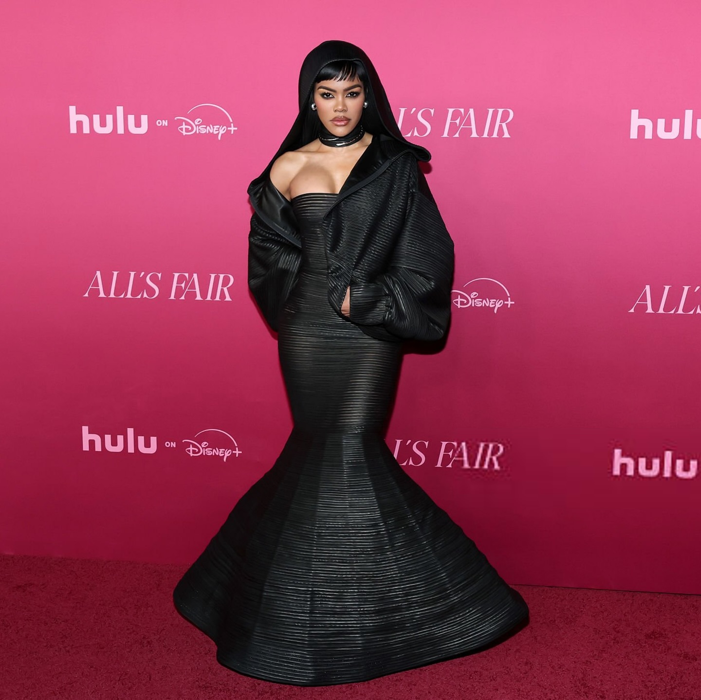 Teyana Taylor wearing a shimmering Cong Tri gown at the All's Fair premiere in Los Angeles, posing confidently on the red carpet