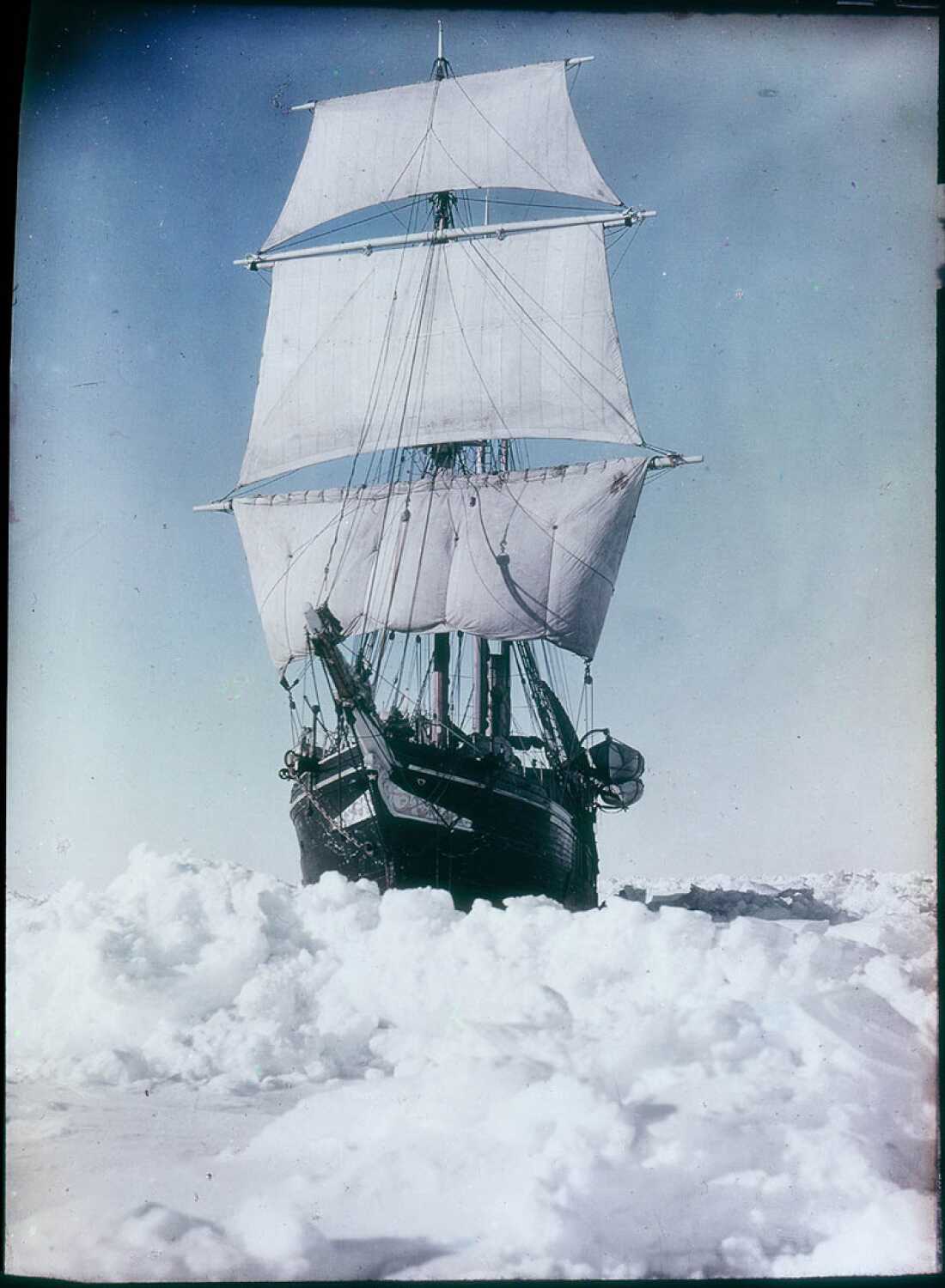 The Endurance surrounded by sea ice in the Weddell Sea, Antarctica, with sails on tall masts.
