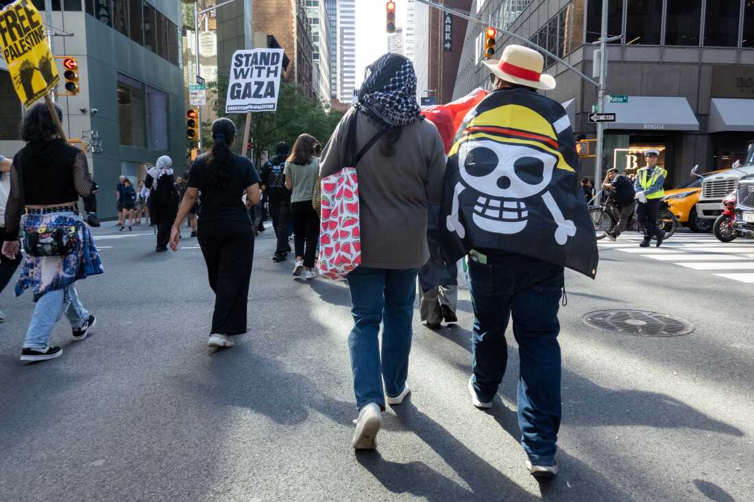 A protester outside the U.N. headquarters wears a Monkey D. Luffy pirate flag from the One Piece manga and anime, New York, Sept. 26, 2025.