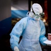 Marburg virus is highly lethal. Rwanda's outbreak response has been hailed internationally for its unprecedented success. This image from a 2014 Kenyan outbreak shows a healthcare worker in protective gear delivering food to a quarantined patient.