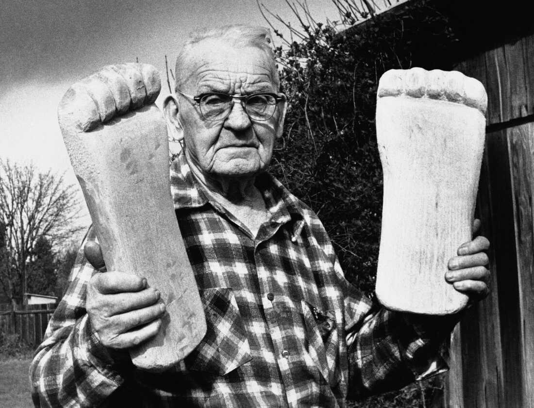 Rant Mullens displaying wooden feet used in Bigfoot hoaxes in the U.S. Northwest, 1982.