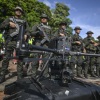Police officers stand behind a drone used to enhance security in Jamundi, Valle del Cauca, Colombia, June 13, 2024.